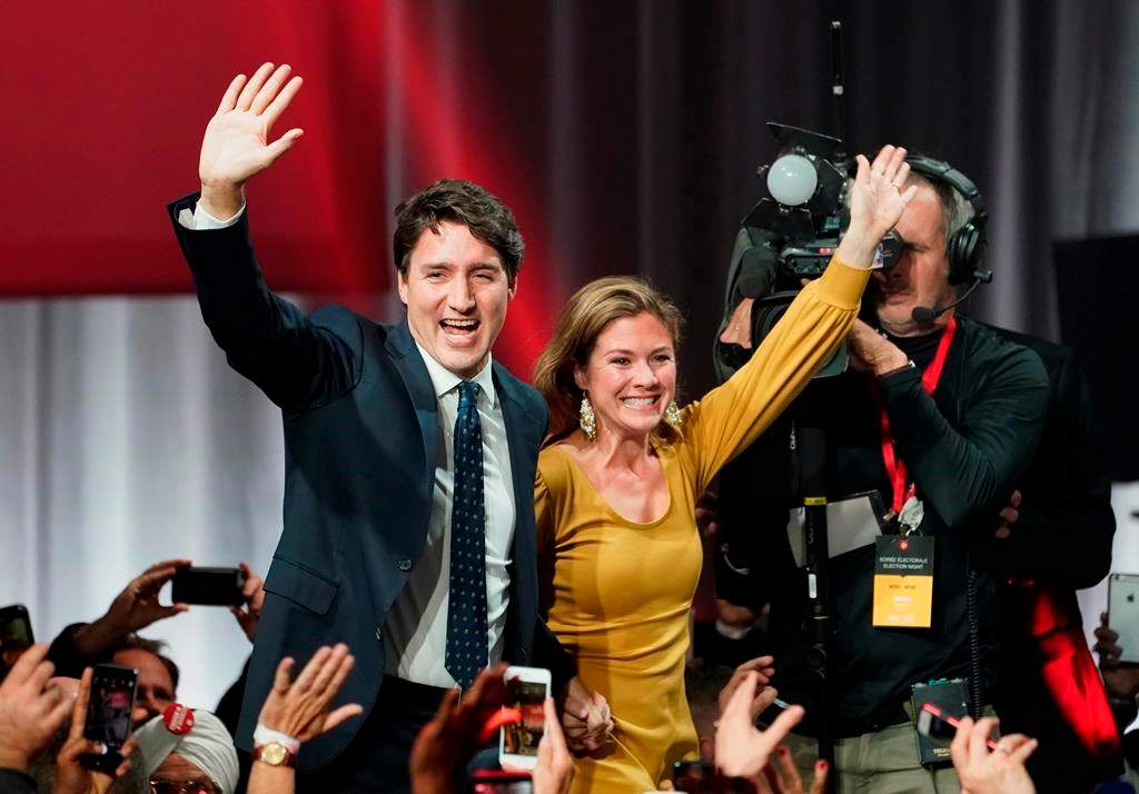 Liberal Leader Justin Trudeau and wife Sophie Gregoire Trudeau wave as they go on stage at Liberal election headquarters in Montreal, Monday, Oct. 21, 2019. THE CANADIAN PRESS/Paul Chiasson