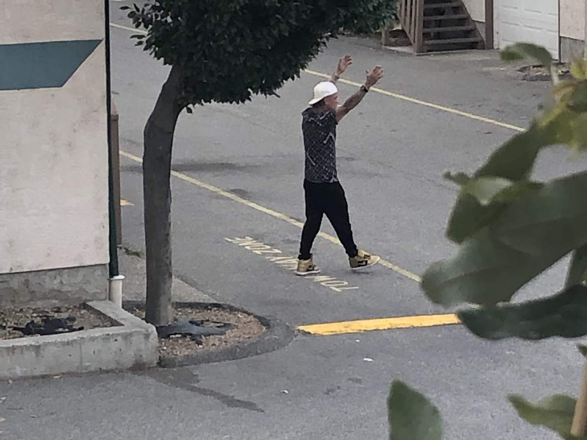 A man surrenders to police during a standoff in Penticton on Wednesday afternoon.