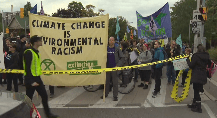 Extinction Rebellion’s Toronto chapter shuts down the Bloor Street Viaduct bridge in a climate change demonstration on Monday.