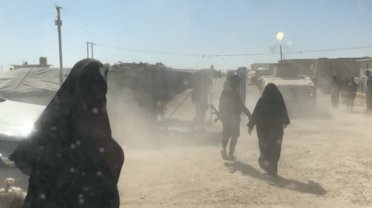 An armed vehicle fires as it enters Al-Hawl camp in northern Syria during a disturbance by ISIS detainees.
