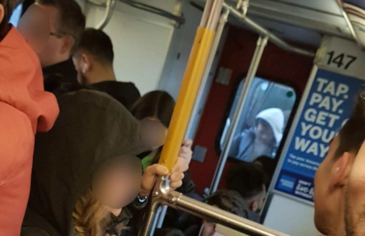 A man rides between SkyTrain cars on Thursday, Oct. 18, 2019. 