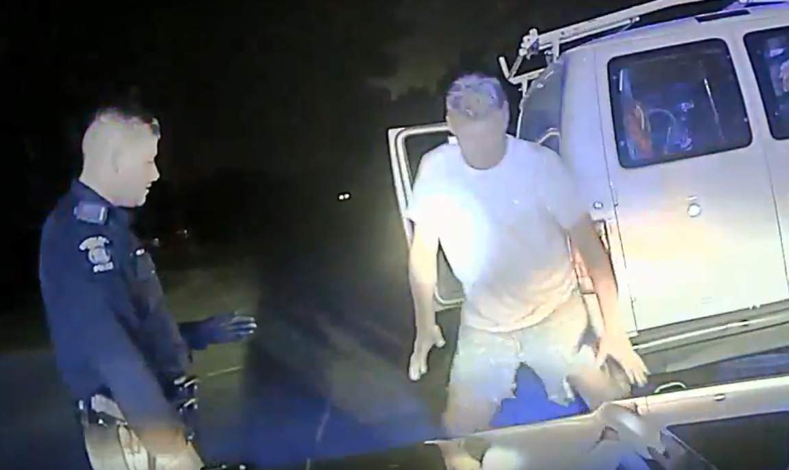 Michael Axelson begins to perform the splits during a roadside stop with police on Sept. 19, 2019, in Sterling Heights, Mich.