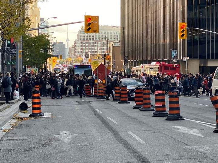 Commuters waiting for shuttle buses after part of Line 1 shut down Tuesday afternoon.