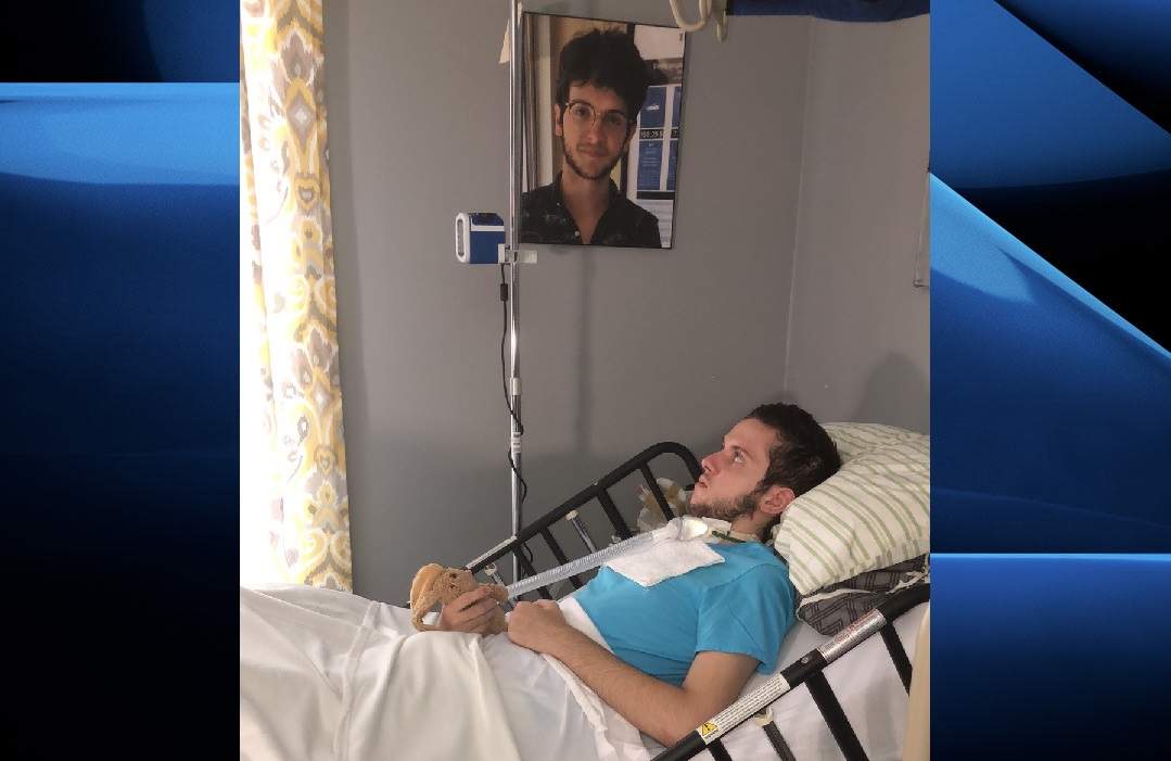 Tristan Roby rests in the living room of his mother's home following a months-long stay at a London hospital.