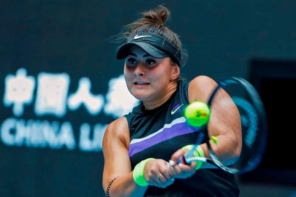 Bianca Andreescu of Canada hits a return shot against Elise Mertens of Belgium during their second round of the women's singles match in the China Open tennis tournament at the Diamond Court in Beijing, Wednesday, Oct. 2, 2019.
