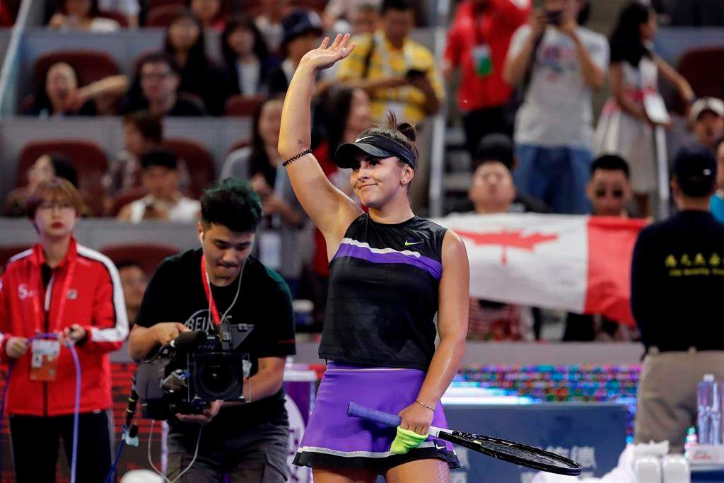 Bianca Andreescu of Canada waves to spectators after defeating Jennifer Brady of the United States in their third round of the women's singles match in the China Open tennis tournament at the Diamond Court in Beijing, Thursday, Oct. 3, 2019.