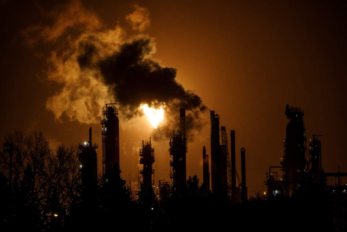 A flare stack lights the sky from the Imperial Oil refinery in Edmonton on December 28, 2018. A lawsuit that's expected to be filed Friday claiming young people disproportionately suffer the effects of climate change is potentially precedent setting but also a tough case to argue, legal experts say.