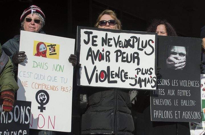 Several women attend a demonstration in Montreal on Friday, Dec. 6, 2013, to highlight violence against women. Fourteen women lost their lives at the hands of a gunman at the École Polytechnique on this day in 1989.