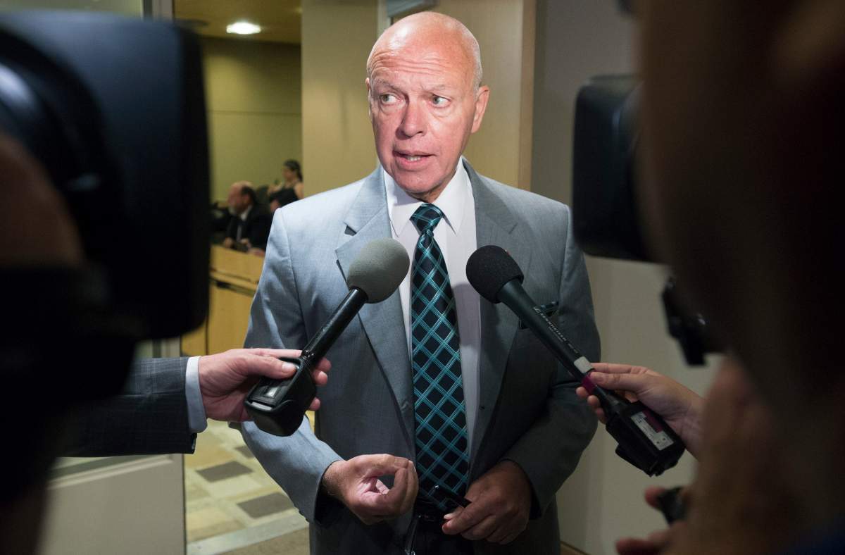 Conservative Senator Jean-Guy Dagenais scrums with media outside a committee in Ottawa on Monday, June 8, 2015. THE CANADIAN PRESS IMAGES/Matthew Usherwood.