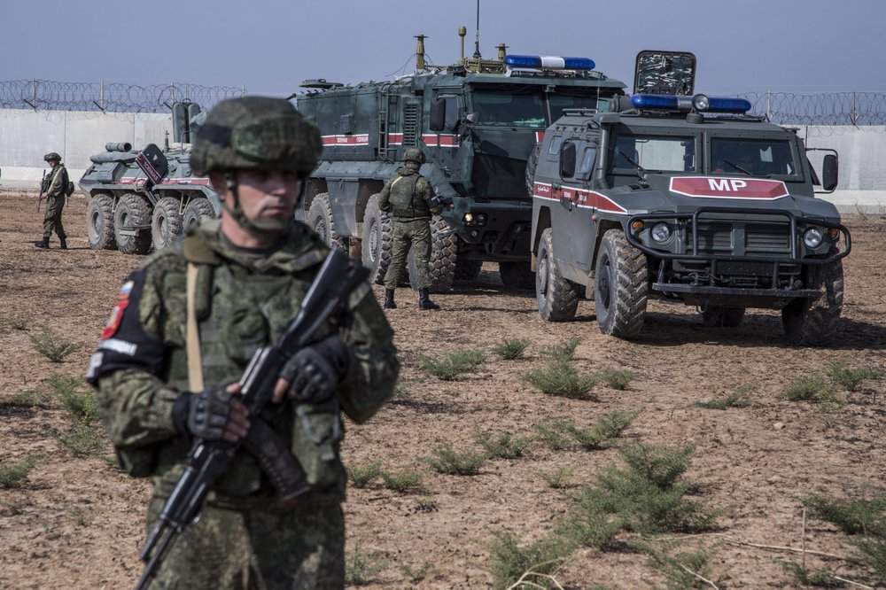 Turkish and Russian patrol is seen near the town of Darbasiyah, Syria, Friday, Nov. 1, 2019.