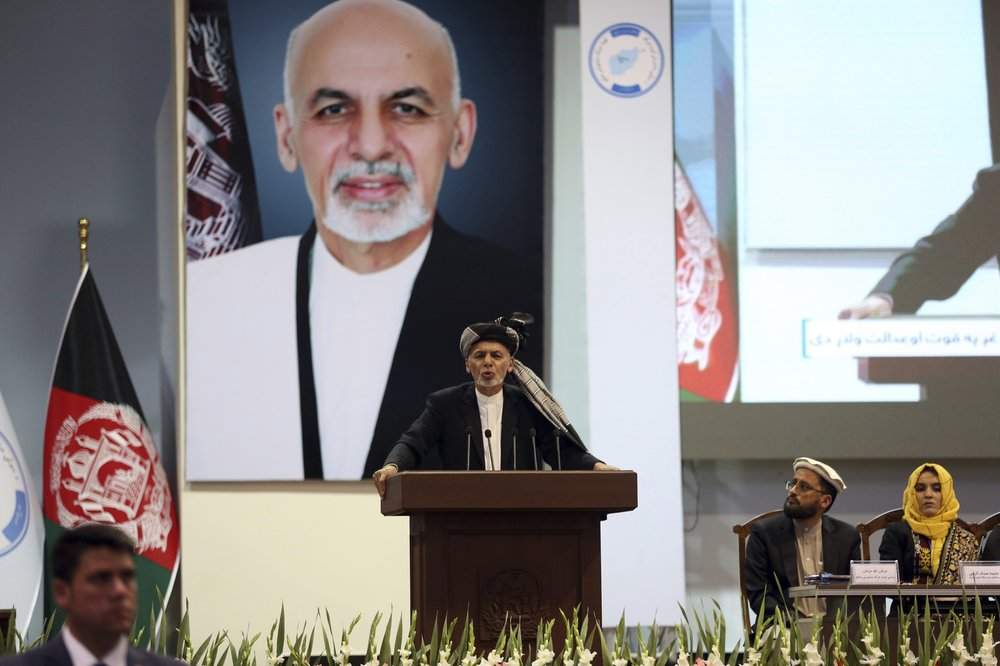 FILE - In this May 3, 2019, photo, Afghan President Ashraf Ghani speaks on the last day of the Afghan Loya Jirga meeting in Kabul, Afghanistan. Taliban officials have told The Associated Press that three Taliban prisoners released by Kabul have been flown to Qatar for a swap for an American and an Australian hostage held by the insurgents. The three Taliban prisoners were to have been freed more than one week ago by Afghan President Ashraf Ghani. 
