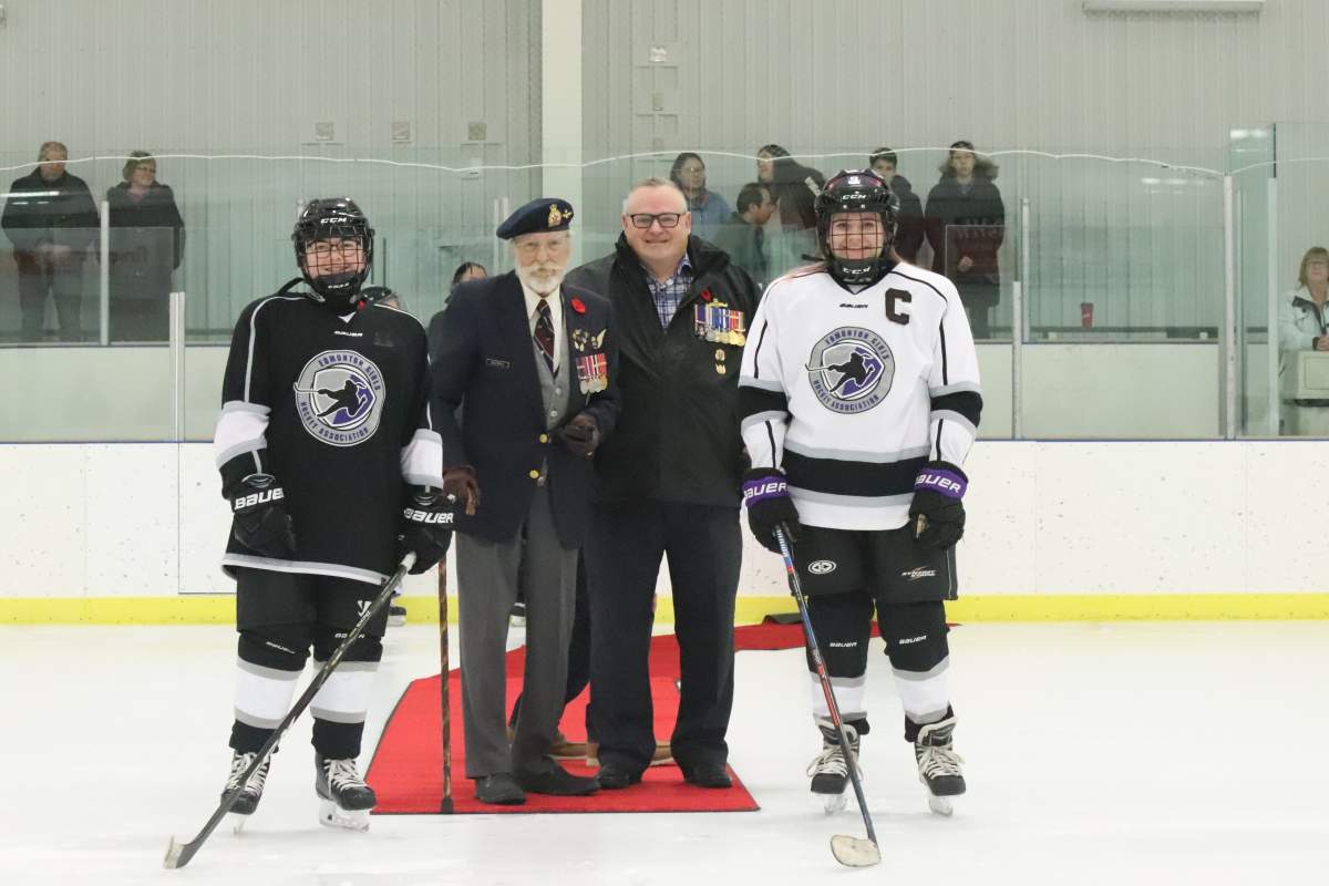 John Kozoriz, a veteran of the Second World War , drops the puck at his great-granddaughter’s hockey game in Edmonton, Alta., on Nov. 11, 2019.