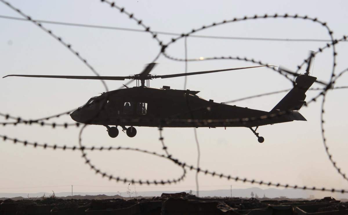 A U.S. Black Hawk military helicopter lands during military exercses in Sohrab camp in Helmand, Afghanistan, 19 November 2017. (EPA/WATAN YAR).