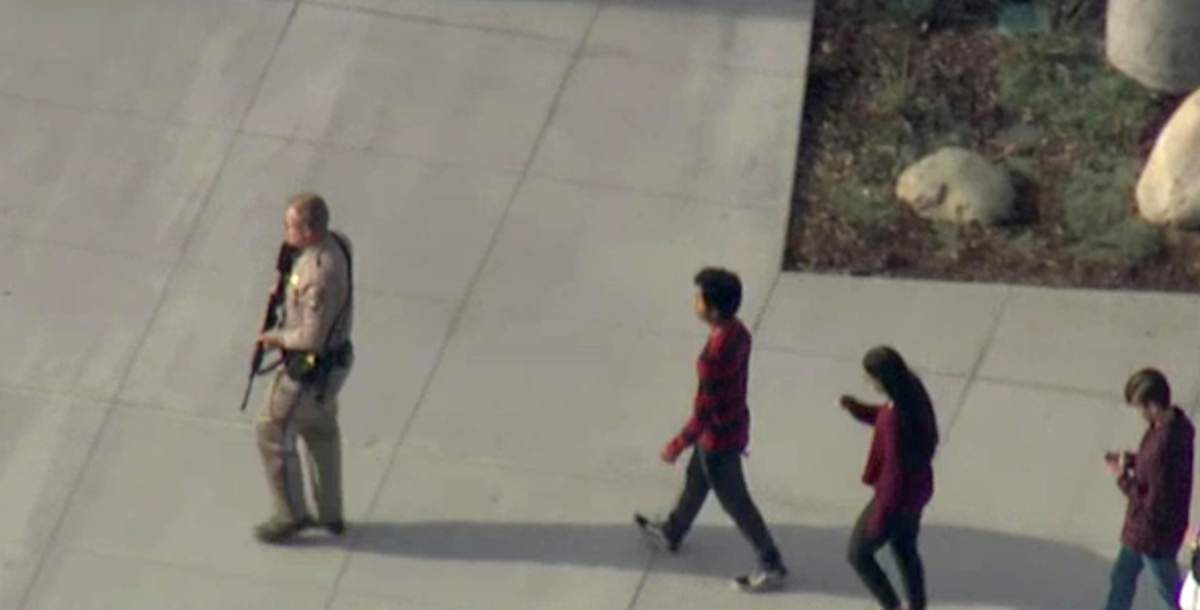 A law enforcement official leads students at the scene of a shooting at Saugus high school in Santa Clarita, California, U.S., November 14, 2019 in this screenshot taken from video footage courtesy of NBCLA. (NBCLA via REUTERS)