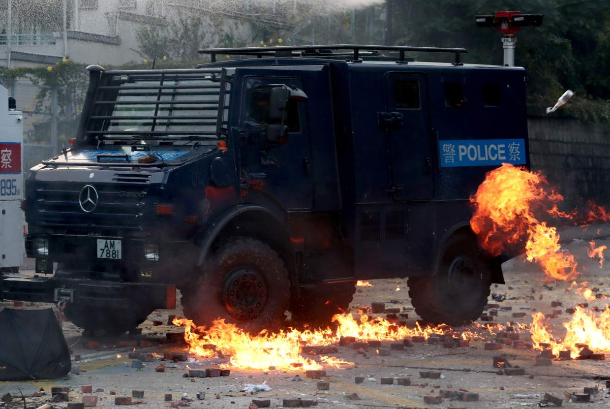 A police vehicle is hit by a Molotov cocktail as anti-government protesters clash with police, outside Hong Kong Polytechnic University (PolyU) in Hong Kong, China, on Nov. 17, 2019. (REUTERS/Athit Perawongmetha)