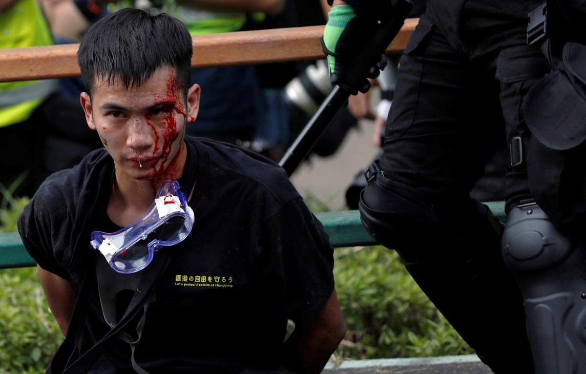 Police detain protesters who attempt to leave the campus of Hong Kong Polytechnic University during clashes with police in Hong Kong, China on Nov. 18, 2019. (REUTERS/Tyrone Siu)