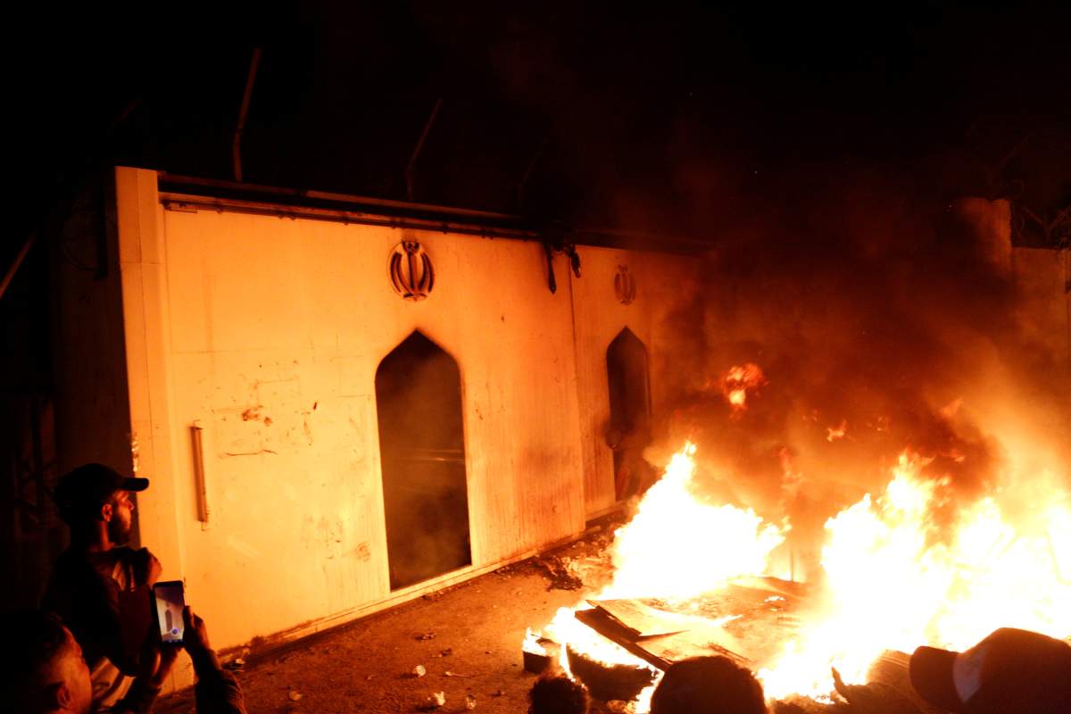 Demonstrators set fire in front of the Iranian consulate, as they gather during ongoing anti-government protests in Najaf, Iraq November 27, 2019.