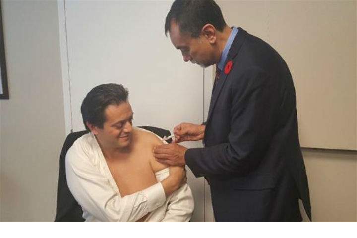 Barrie Mayor Jeff Lehman, left, receives his flu shot from Ontario Medical Association president Dr. Sohail Gandhi. The two met briefly on Monday to get acquainted and discuss the importance of immunization in the community.