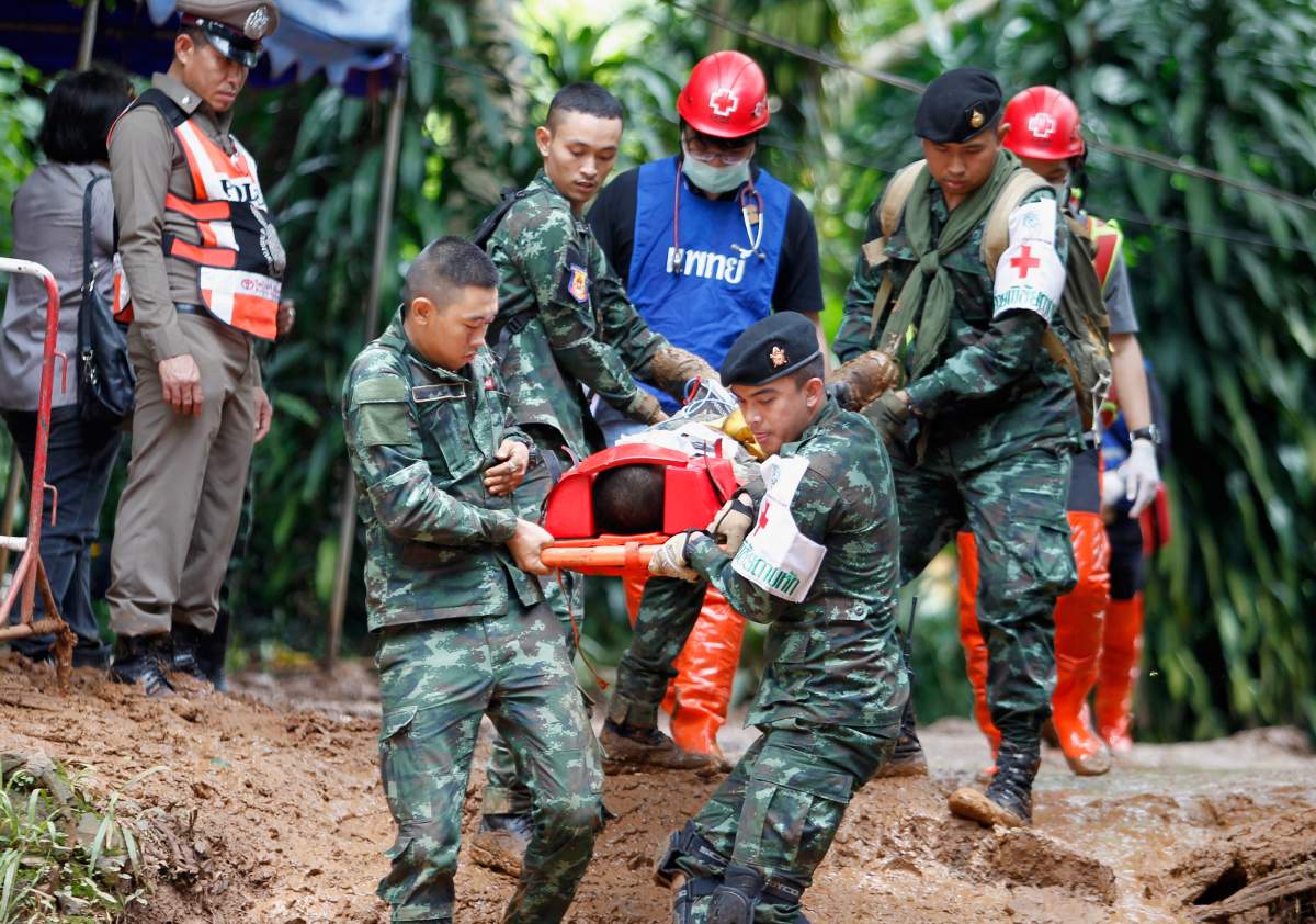 Thai military medical personnel and associated officials practice carrying an injured person during an emergency exercise near the Tham Luang cave in Tham Luang Khun Nam Nang Noon Forest Park in Chiang Rai province, Thailand, 30 June 2018.