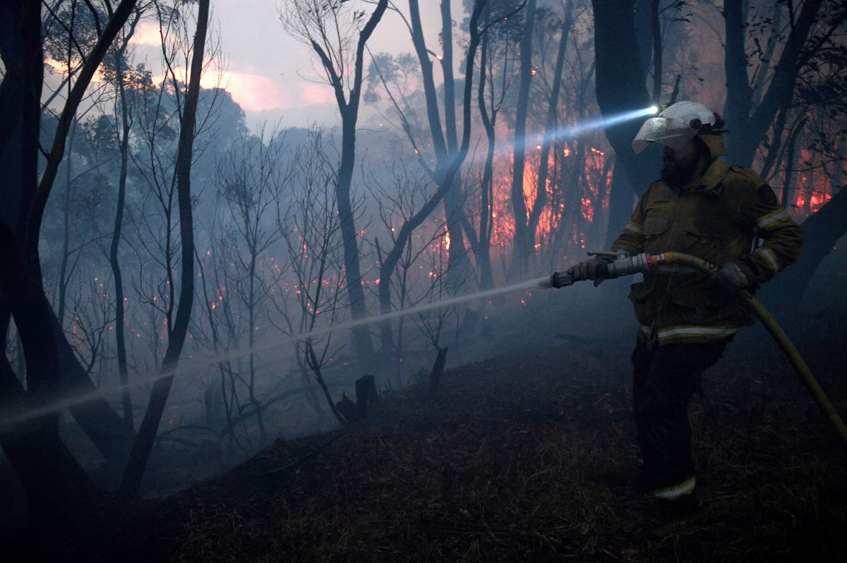 NSW Rural Fire Service firefighters conduct property protection as a bushfire burns close to homes on Railway Parade in Woodford, New South Wales (NSW), Australia, 08 November 2019. (EPA/DAN HIMBRECHTS AUSTRALIA AND NEW ZEALAND OUT)