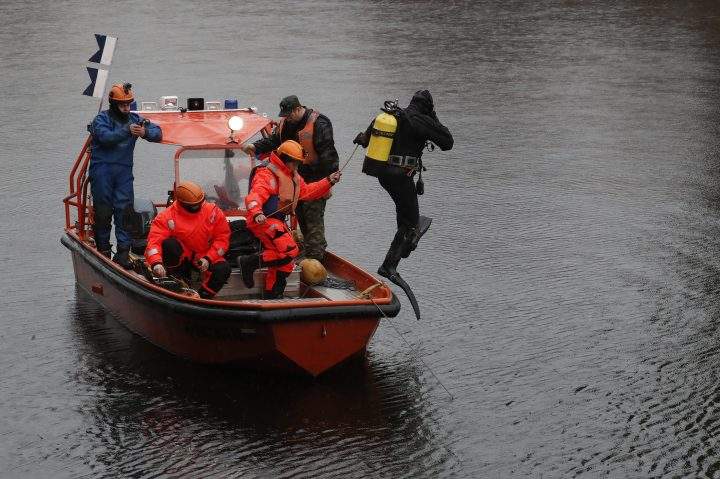 Rescuers examine the bottom of the Moika River where the remains of a student killed by Oleg Sokolov were found in St. Petersburg, Russia, on Nov. 10, 2019.