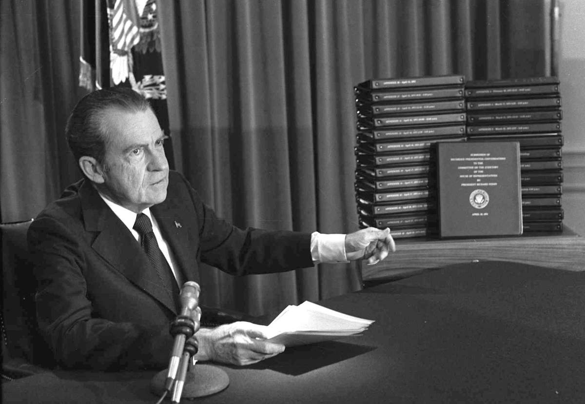 In this April 29, 1974 file photo, President Richard M. Nixon points to the transcripts of the White House tapes in Washington, after he announced on television that he would turn over the transcripts to House impeachment investigators. (AP Photo/File)