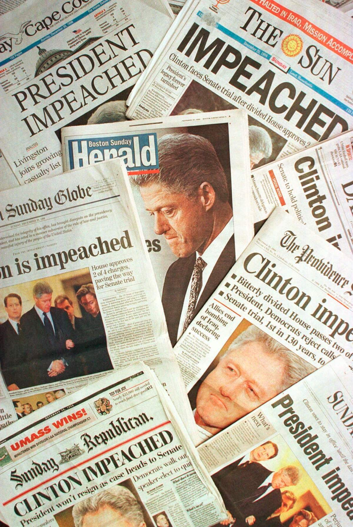 This is a photo montage showing the Sunday, Dec. 20, 1998 editions of newspapers from Massachusetts and Rhode Island with headlines of President Clinton’s impeachment. (AP Photo/Peter Lennihan)
