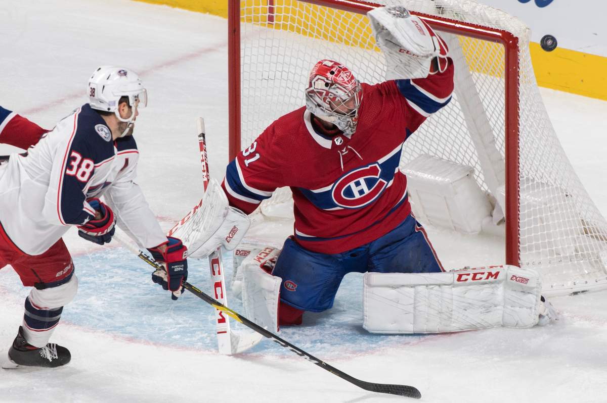 Columbus Blue Jackets' Boone Jenner (38) moves in on Montreal Canadiens goaltender Carey Price during first period NHL hockey action in Montreal, Tuesday, Nov. 12, 2019. 