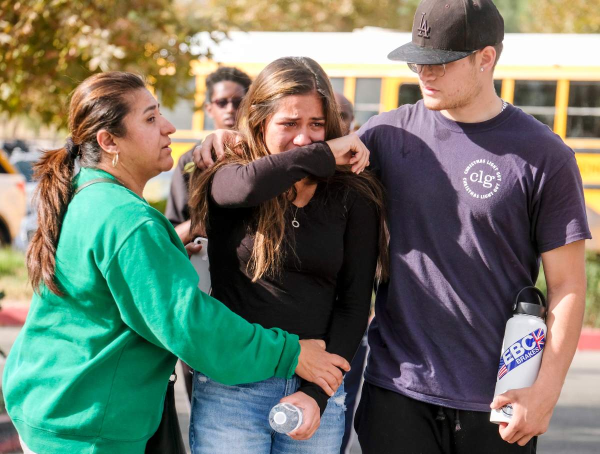 A student is comforted as she reunite at a park following a shooting at Saugus High School that injured several people, Thursday, Nov. 14, 2019, in Santa Clarita, Calif.