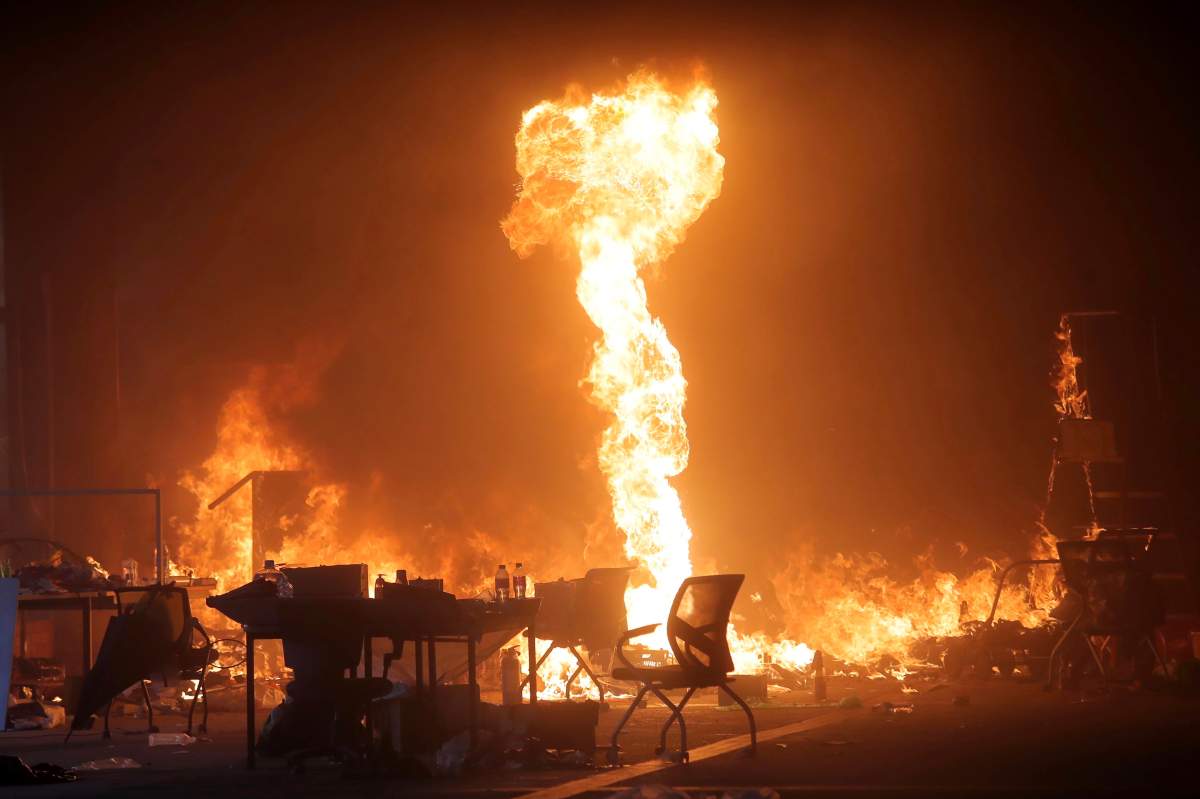 A fire set by protesters burns at the Hong Kong Polytechnic University campus in Hong Kong, Monday, Nov. 18, 2019. (AP Photo/Kin Cheung)
