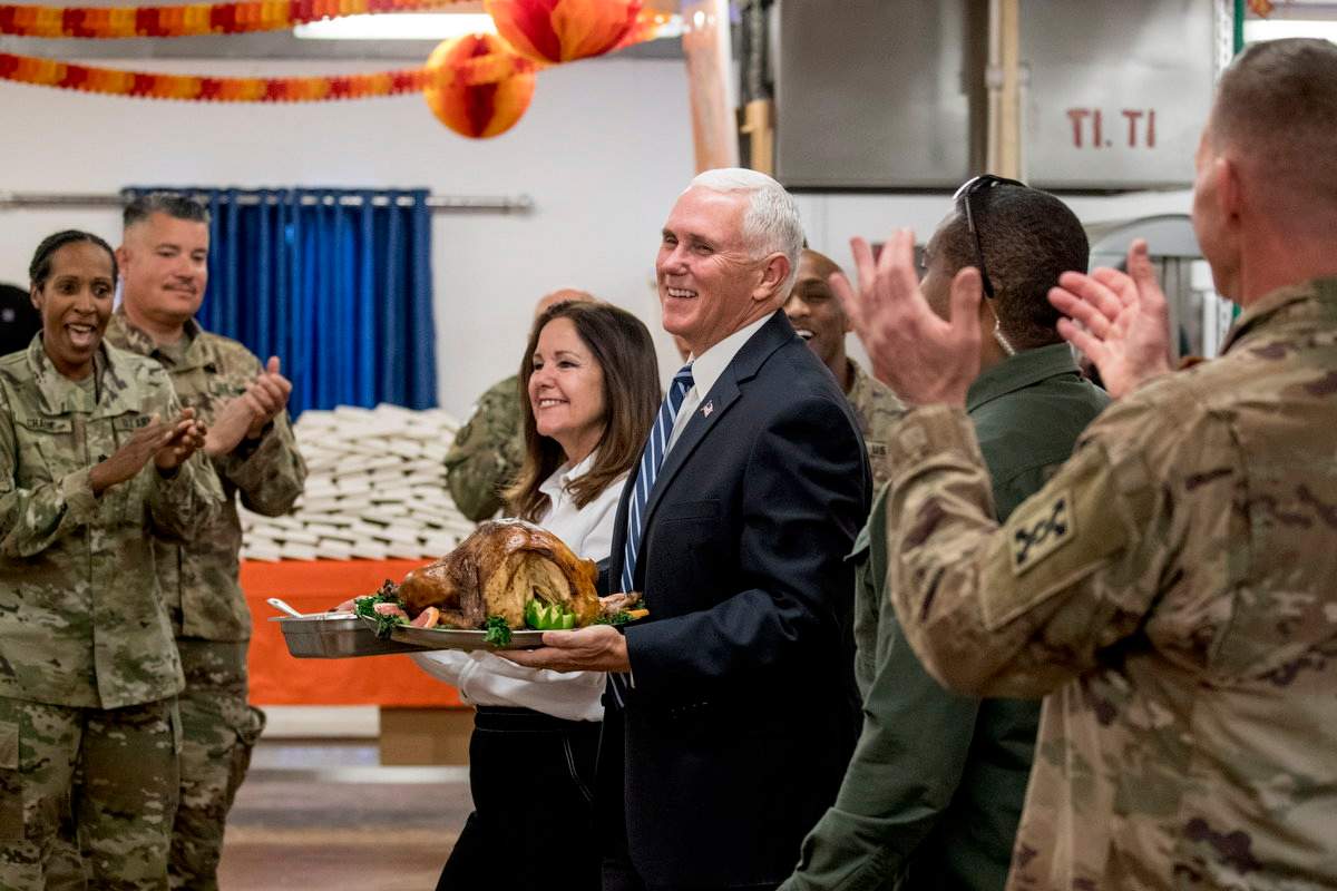 Vice President Mike Pence and his wife Karen Pence arrive with turkey to serve to troops at Al Asad Air Base, Iraq, Saturday, Nov. 23, 2019. (AP Photo/Andrew Harnik)