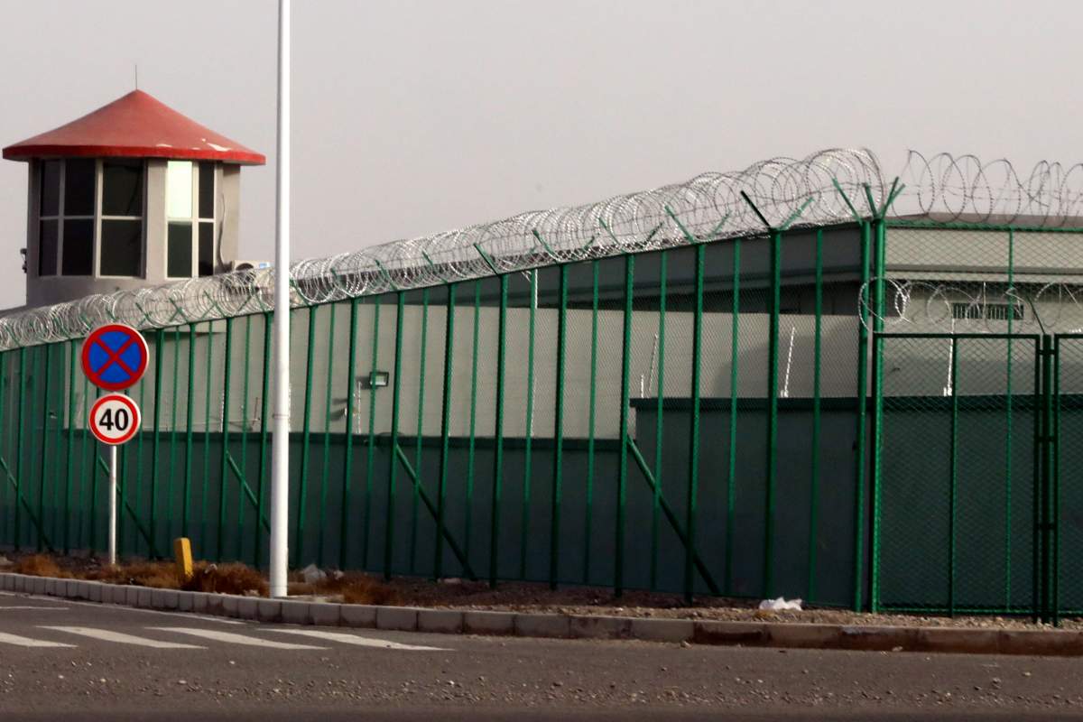 FILE.- In this Monday, Dec. 3, 2018, file photo, a guard tower and barbed wire fences are seen around a section of the Artux City Vocational Skills Education Training Service Center in Artux in western China’s Xinjiang region. This is one of a growing number of internment camps in the Xinjiang region, where by some estimates over 1 million Muslims have been detained, forced to give up their language and their religion and subject to political indoctrination.  (AP Photo/File)