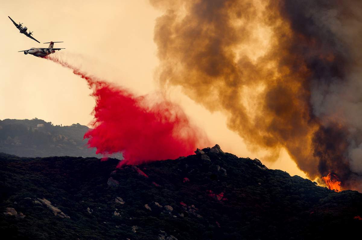 An air tanker drops retardant to slow the Cave Fire burning in Los Padres National Forest, Calif., above Santa Barbara on Nov. 26, 2019.