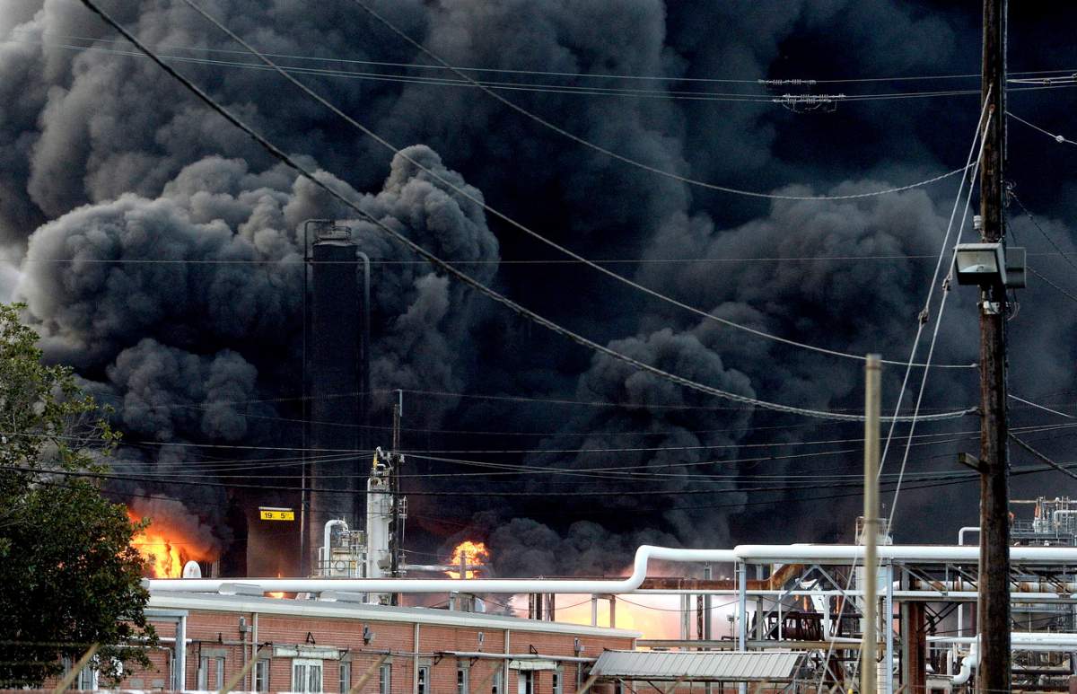 Thick smoke fills the sky above the TPC plant. (Kim Brent/The Beaumont Enterprise via AP)