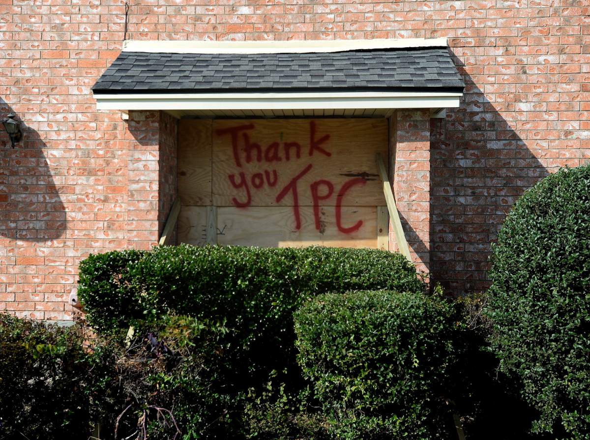 A boarded-up window bears a message for TPC Group as residents and business owners throughout Port Neches, Texas clean up from the damage. (Kim Brent/The Beaumont Enterprise via AP)