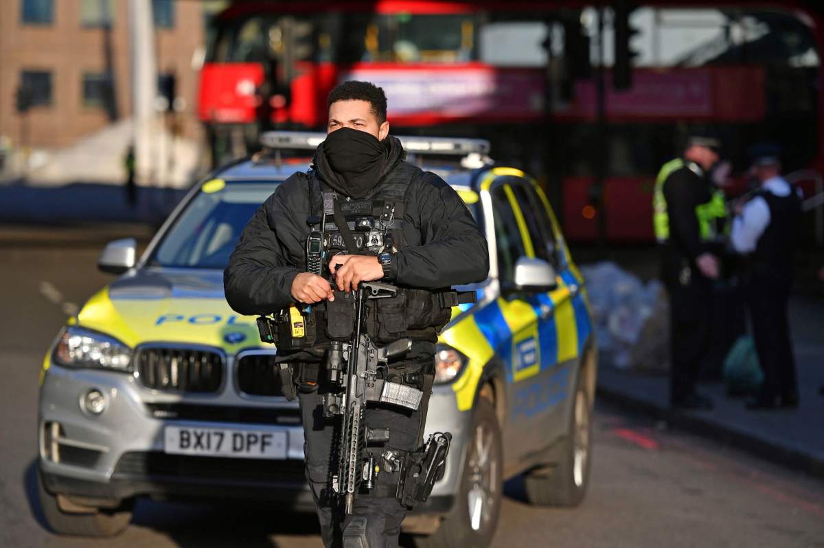 Armed police and emergency services at the scene of an incident on London Bridge in central London following a police incident, Friday, Nov. 29, 2019.  (Dominic Lipinski/PA via AP)