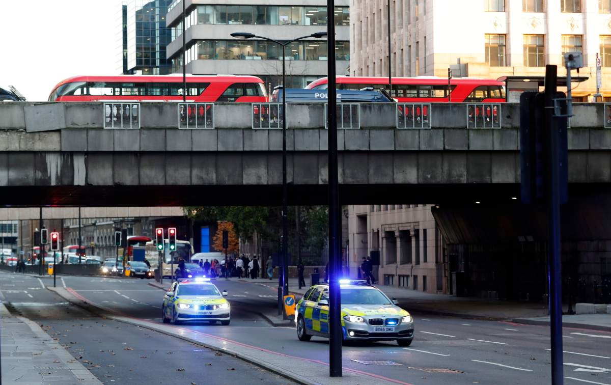 Police vehicles drive underneath London Bridge in London, Friday, Nov. 29, 2019. (AP Photo/Frank Augstein)