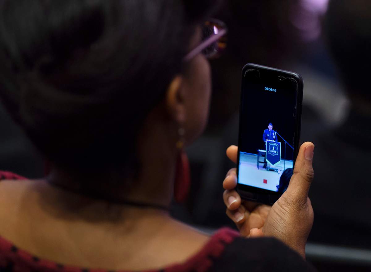 A community member makes a recording as Halifax Regional Police Chief Dan Kinsella addresses the audience as the force deals with historic complaints of racial profiling in Halifax on Friday, Nov. 29, 2019. Kinsella apologized for years of police street checks that disproportionately targeted black people. THE CANADIAN PRESS/Andrew Vaughan