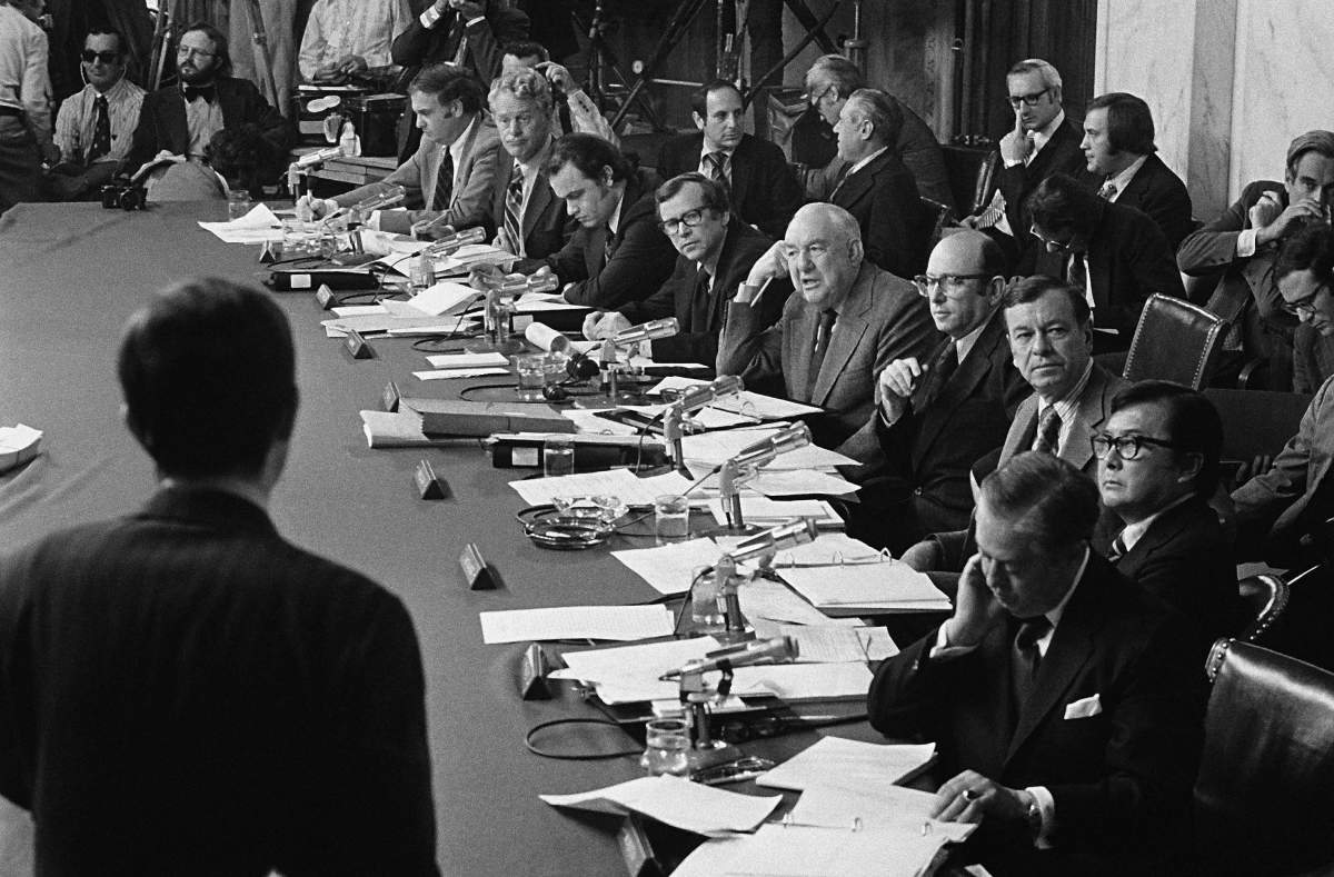 Members of the Senate Watergate Investigating Committee are seen during a hearing on Capitol Hill in Washington as they listen to witness Robert Odle, foreground, in this May 17, 1973 file photo. (AP Photo/File)
