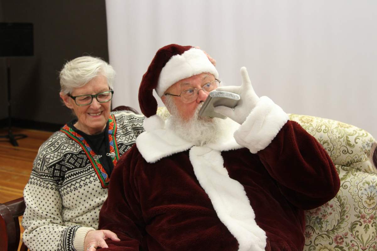 Gary Haupt pretends to drink from a flask at the Shatford Centre Christmas market on Saturday.