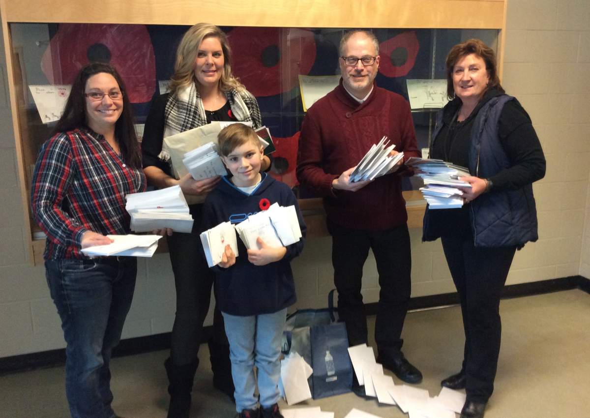 (From left) Joan Laythorpe, Donna Roth, Jordan Roth, Bruce Winston and Jean Hugill hold some of the more than 700 cards that will be sent to Canadian soldiers overseas this winter. 