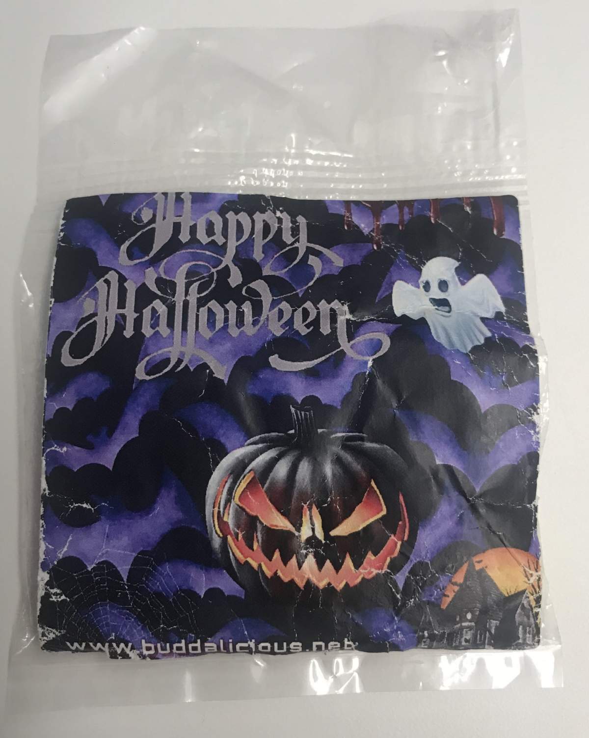 The package has a Halloween-themed label on the front and contains several jujube candies inside. A sticker on the back of the package indicates THC content of the candies.