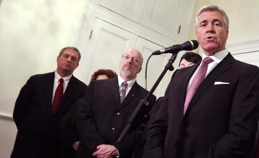 Newfoundland and Labrador Liberal Party Leader Dwight Ball, joined by members of his cabinet, Gerry Byrne, and Perry Trimper, speaks with the media after being sworn in as the province's 13th premier at Government House, in St. John's, N.L., on Monday, Dec. 14, 2015.
