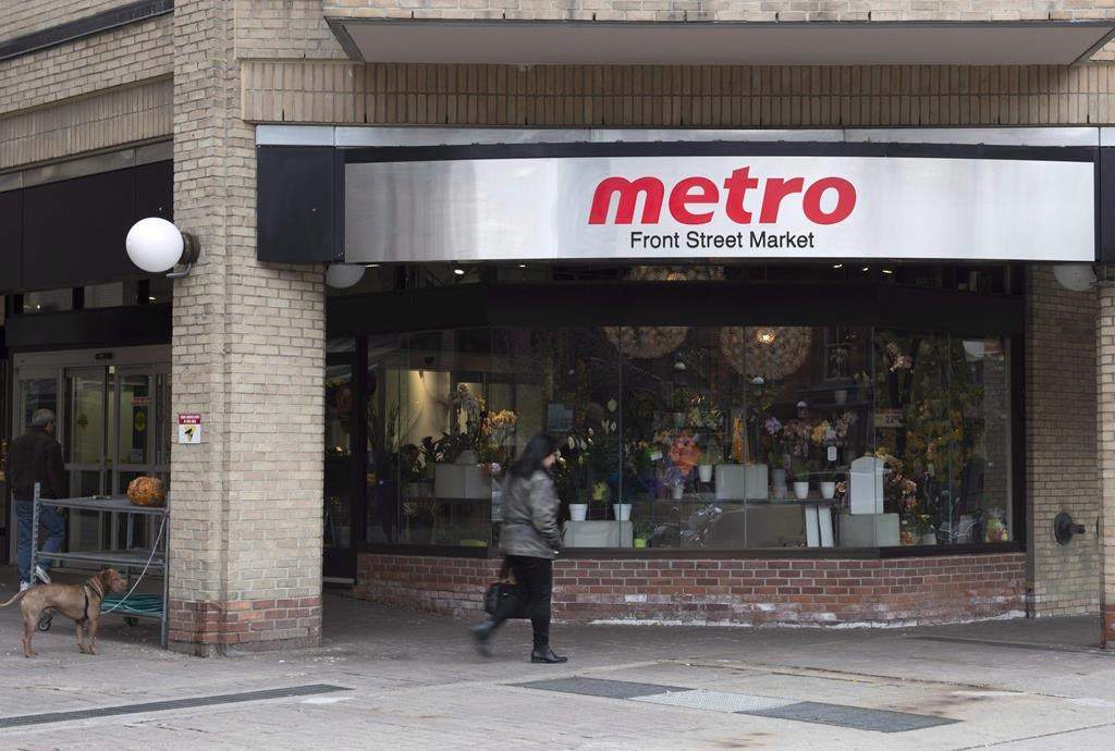 A woman walks pass a Metro grocery store in Toronto on Wednesday Nov. 1, 2017.