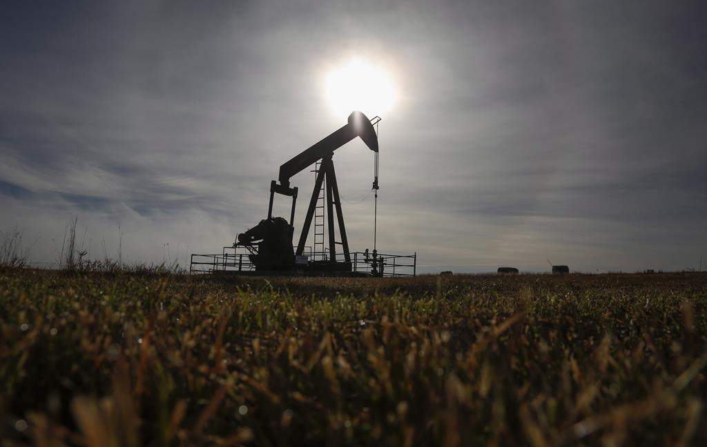A pumpjack works at a well head on an oil and gas installation near Cremona, Alta., Saturday, Oct. 29, 2016.  