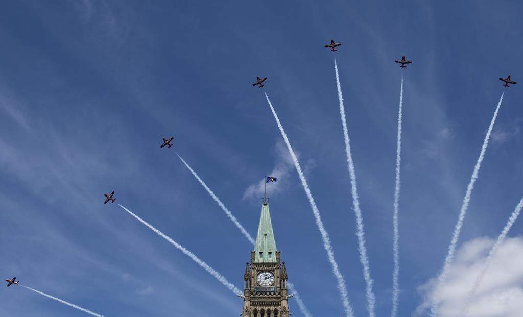 Royal Canadian Air Force Snowbirds fly past the Peace Tower during the Canada Day noon show on Parliament Hill in Ottawa on Monday, July 1, 2019.