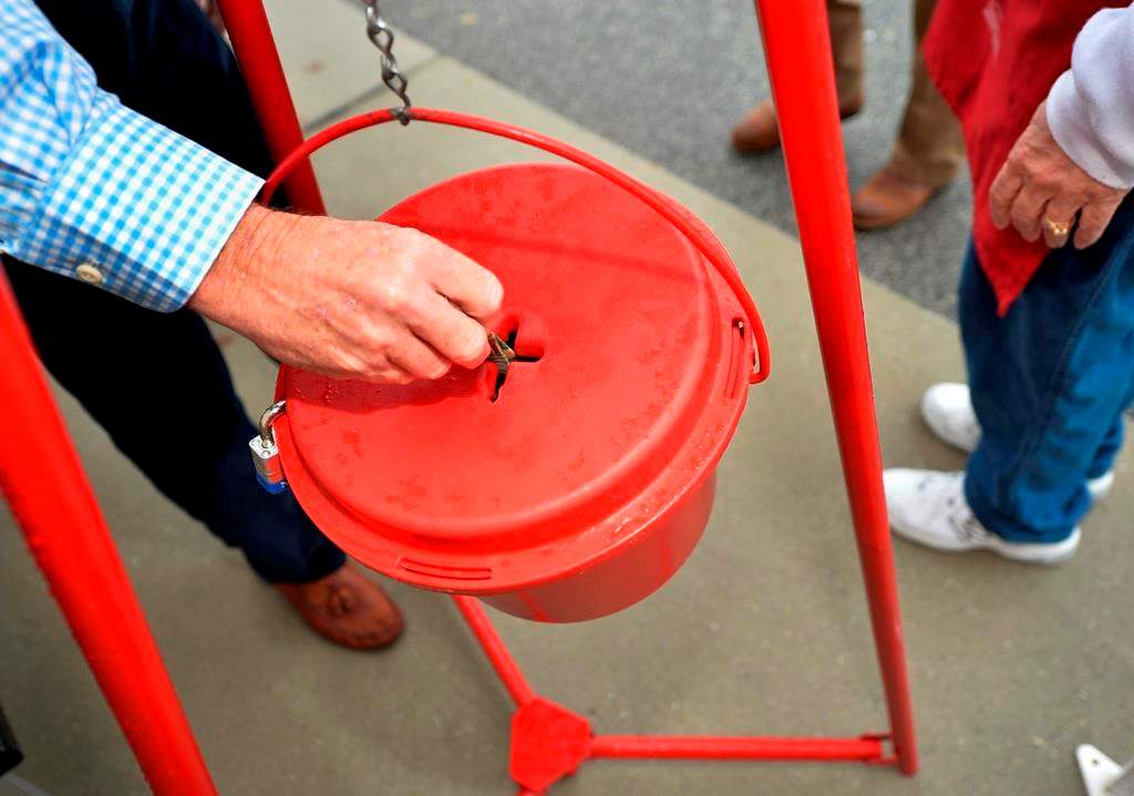 Money gets dropped into the kettle during the Annual Salvation Army Red Kettle donation drive. THE CANADIAN PRESS/AP-Michael Holahan.