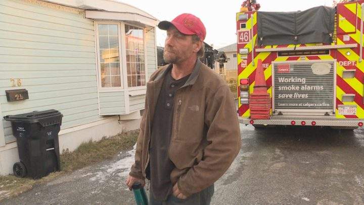 Daniel St. Germain stands outside of the burnt-out trailer in Calgary he helped a mother and son escape from six hours prior on Saturday, Nov. 2, 2019.