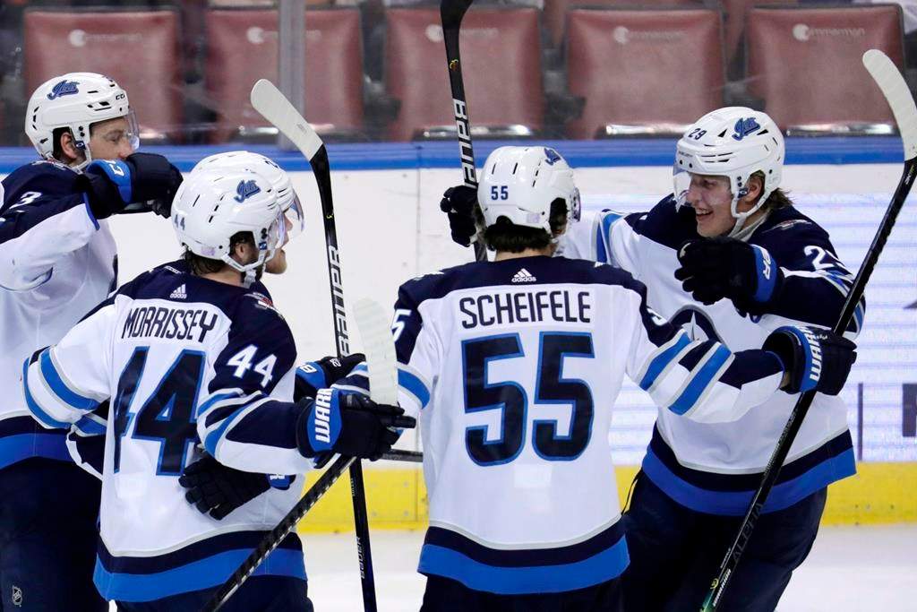 Winnipeg Jets right-wing Patrik Laine, right, celebrates with defenceman Josh Morrissey (44) and centre Mark Scheifele (55) after scoring a goal during the third period of an NHL hockey game against the Florida Panthers, Thursday, Nov. 14, 2019, in Sunrise, Fla.