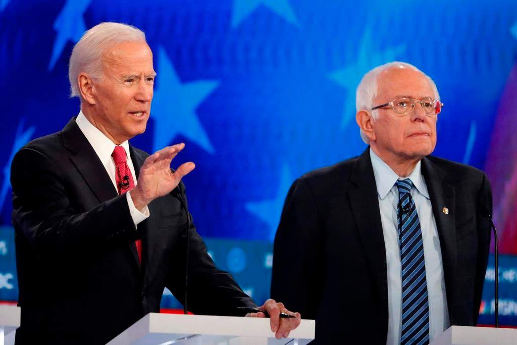 Democratic presidential candidate former vice-president Joe Biden, left, speaks as Democratic presidential candidate Sen. Bernie Sanders, I-Vt., listens during a Democratic presidential primary debate, Wednesday, Nov. 20, 2019, in Atlanta, Ga.